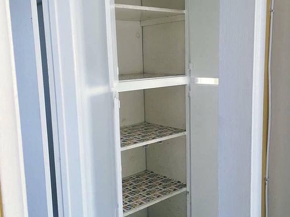 Linen space between bedroom and bath.