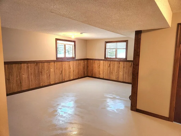 Lower level with finished family room, office, bathroom, and laundry room.