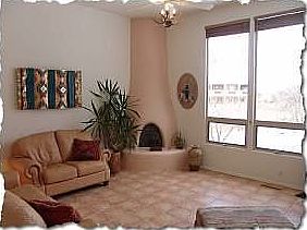 Light bright open living area with kiva fireplace