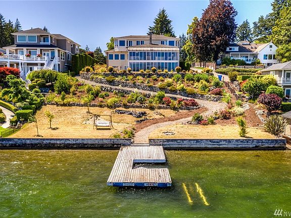 Landscaped yard with walking path down to 100ft of lake front and dock. 