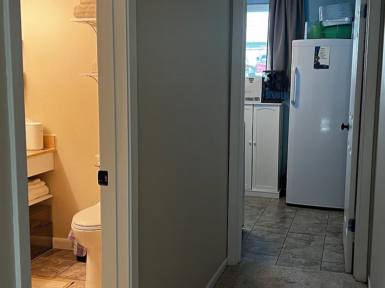 View of path to the bathroom and laundry room, just up a few stairs on the lower level.