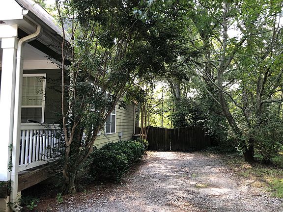 Front driveway to fence gate leads to extra parking space in the back
