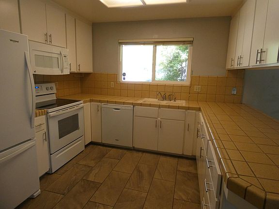 Kitchen has microwave, dishwasher and almost-new refrigerator with bottom freezer.