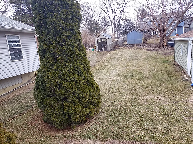 Backyard - from fence to other side of garage- view from rear deck.