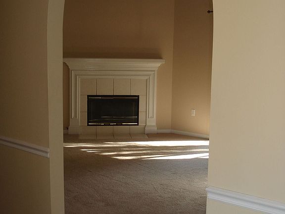 foyer entance, lots of arches, wood burning fireplace