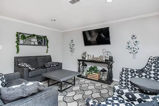 Stylish resident lounge featuring seating, a fireplace, and a flat-screen TV_perfect for relaxing or socializing.