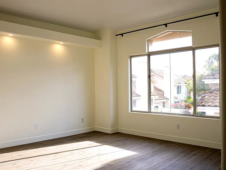 Modern master bedroom with recessed lighting.