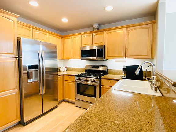 Kitchen with granite countertops and stainless steel appliances.