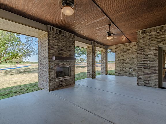 Enclosed Back Porch with Fireplace and Gashookup for Grill at Landmark Fine Homes