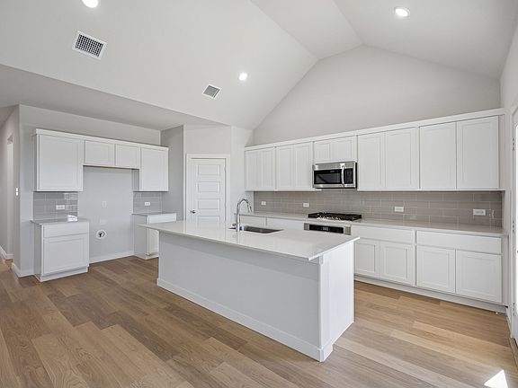 Kitchen in the Wimbledon home plan by Trophy Signature Homes - REPRESENTATIVE PHOTO