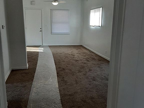 View from kitchen doorway of living/dining room; bedrooms are to left on north side of home