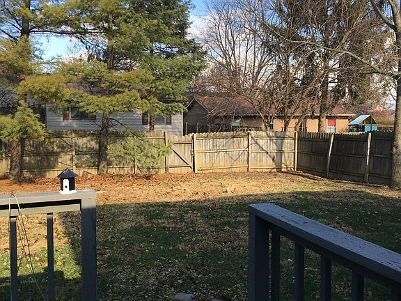 Large fenced backyard with a deck.