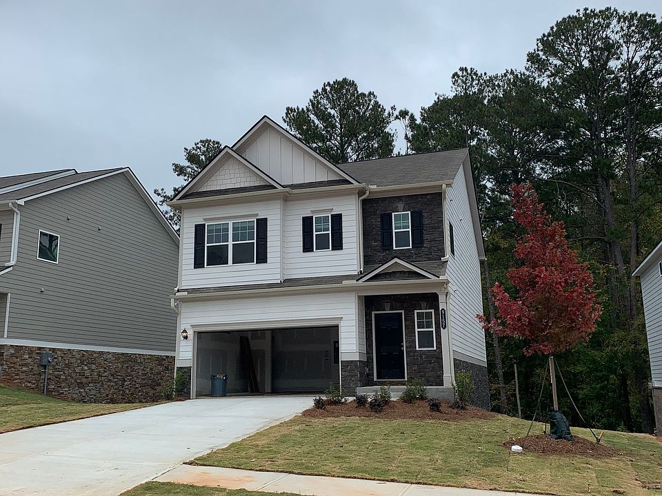Welcoming two-story home with attached 2-car garage and driveway parking.