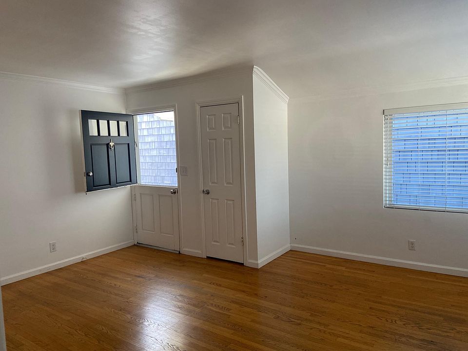 Dutch door gives light, airy, cottage feel and coat closet provides extra storage
