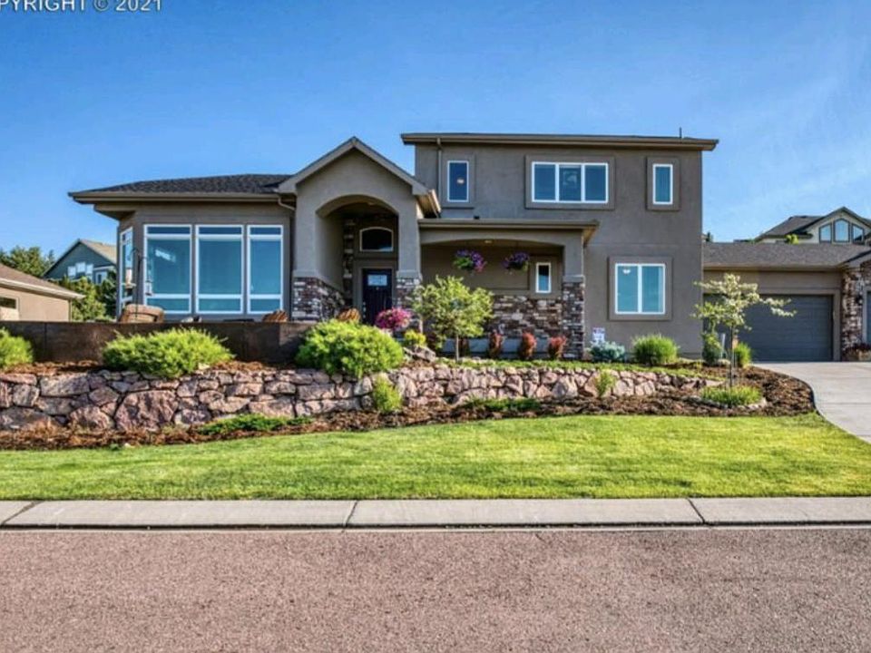 South facing custom 4 bedroom/ 3 bath/ 3 car garage with beautifully landscaped yard front porch & patio