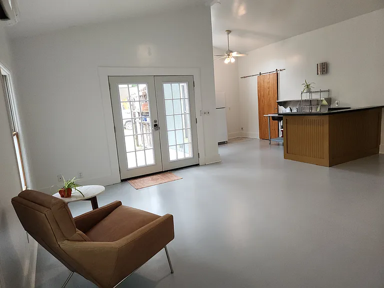 Additional view of living / kitchen area; pantry door (with w/d hookup); back door out to porch, yard and parking area