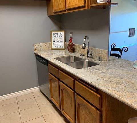 Kitchen with Tile Flooring and ample cabinet space