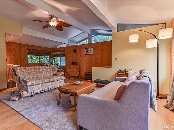 Entry and living room. Large wood fireplace to the left of sofas, not pictured.
