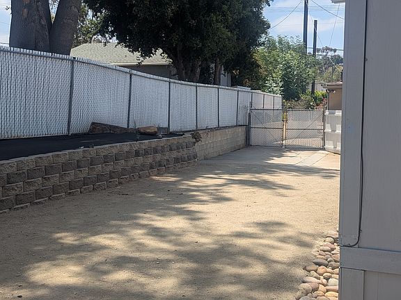 Driveway leading out to msin street. Locking gates for security