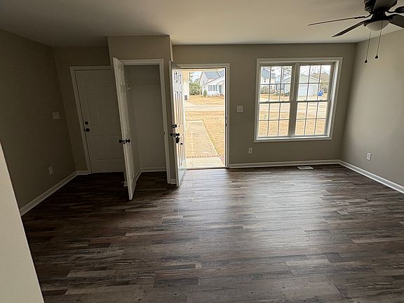 Living room, coat closet, garage entry door
