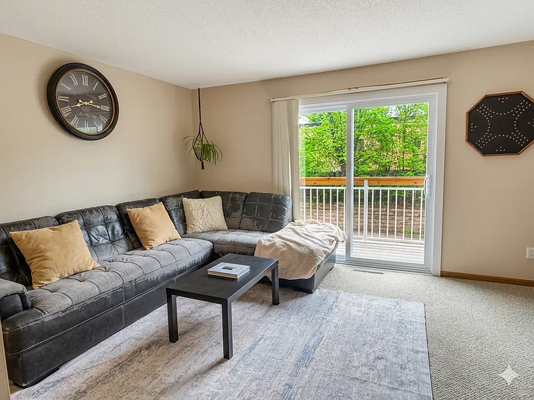 The living room is spacious and offers easy access to your private deck