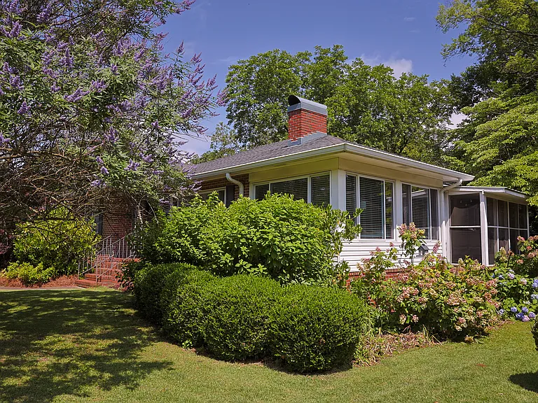 This view shows the adjoining screened porch & sunroom. The sunroom gets incredible morning light, and is the perfect spot for indoor plants to thrive! Hydrangea, echinacea, dahlias, black-eyed susans, daffodils, hyacinth, & gardenias bloom outside.