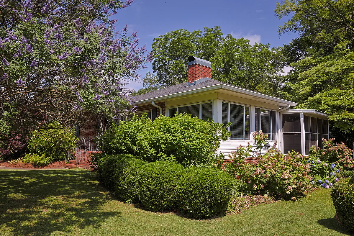This view shows the adjoining screened porch & sunroom. The sunroom gets incredible morning light, and is the perfect spot for indoor plants to thrive! Hydrangea, echinacea, dahlias, black-eyed susans, daffodils, hyacinth, & gardenias bloom outside. - 5716 8th Ave S