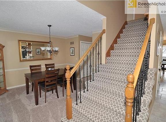 Classic 2-story with iron spindles and BRAND NEW carpet on the center staircase