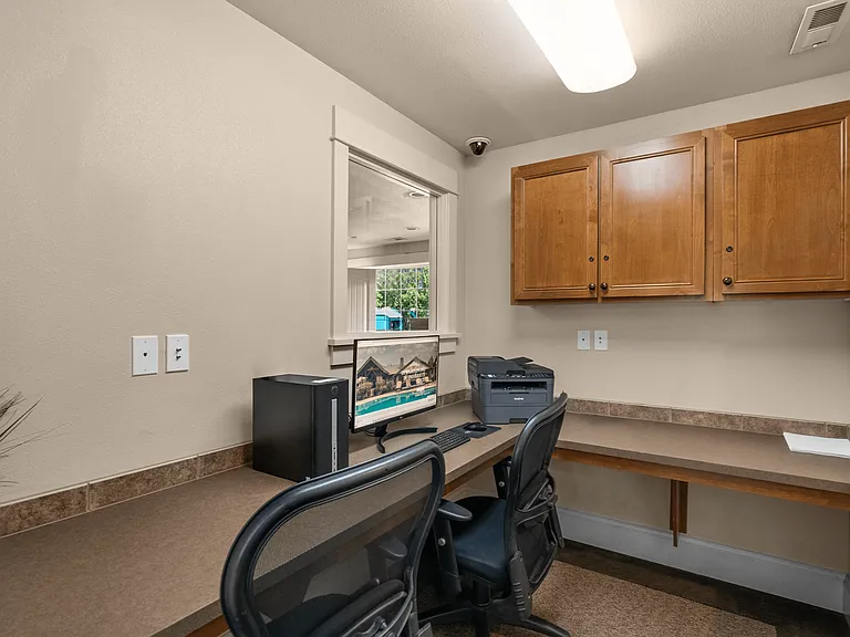 Business center with workstations and printer access.
