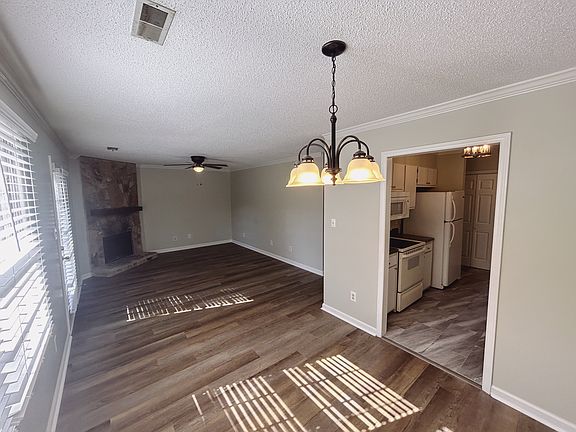 Dining connexts to open living space with new flooring, new light fixtures and fresh paint