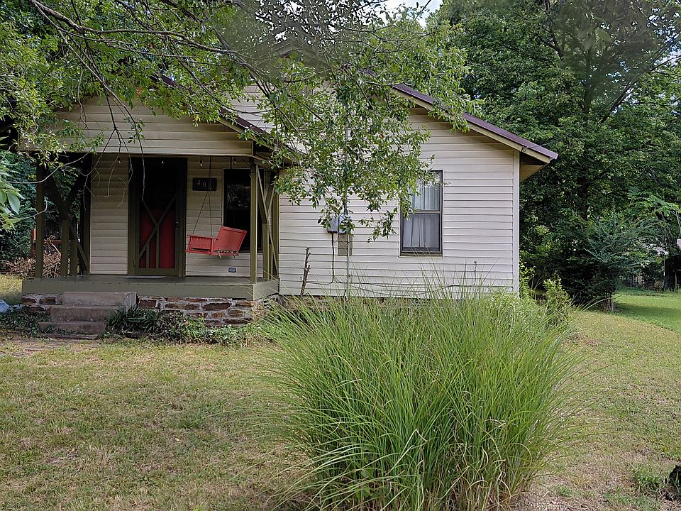 Exterior from street, driveway has several parking spaces