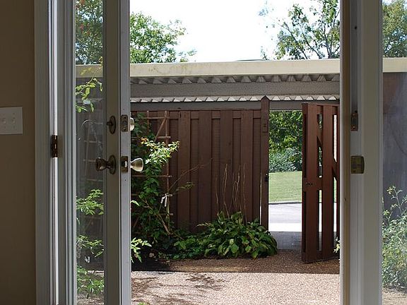 Enclosed patio leading to carport.