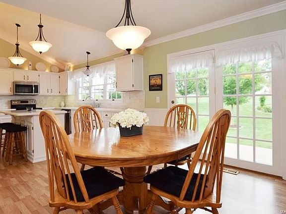 Kitchen opens to breakfast room with French door leading to patio and out to your serene & private backyard.