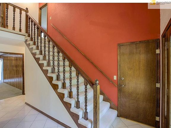 Gallery entry with tile floors and coat closet.