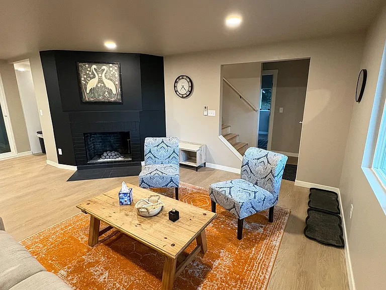 Inviting living room with a fireplace accent wall, comfortable seating area, and durable flooring for easy everyday living.