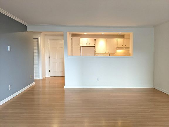 View from the living room looking at the entry door and kitchen