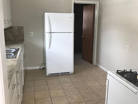 Kitchen with new refrigerator and new dishwasher