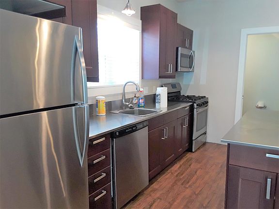 Kitchen with stainless steel appliances and countertops