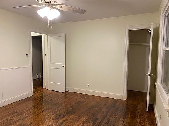 Master bedroom with closet and door that leads to hallway