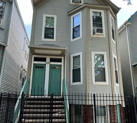 front of building. Apartment door on the right