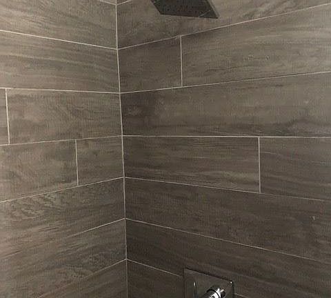 Modern wood grain tile shower with rain shower head