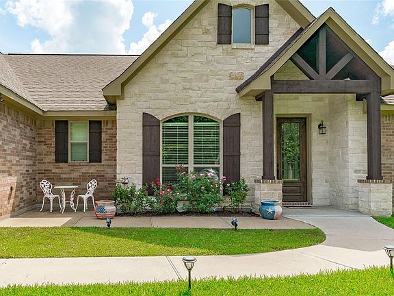 Beautiful stone entry with wooden trusses and beams!