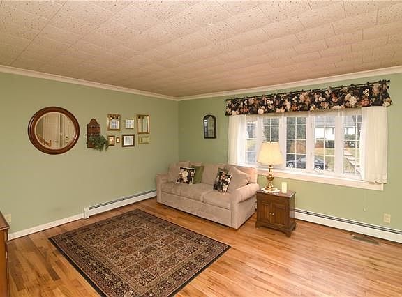 Large pane window lets the natural light in to make this a bright living room.