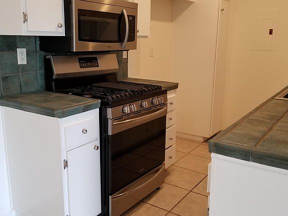 Kitchen with stainless appliances (tile color may vary)
