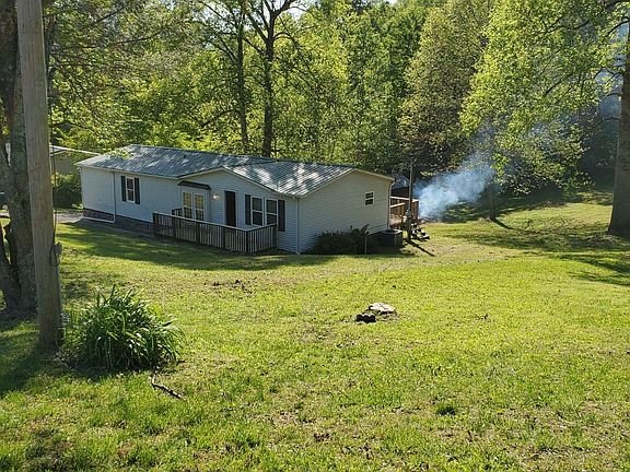 Picture from the road when approaching the front of the house. The smoke in the rear is from burning debris in the firepit that was cleaned up from the yard.