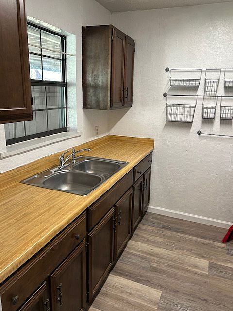 galley kitchen with gas stove and fridge