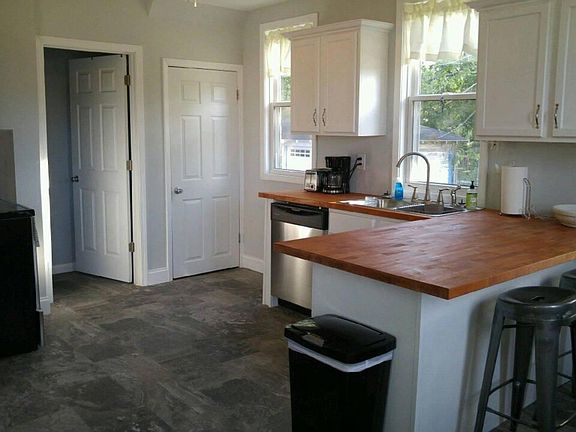 kitchen appliances including pots, pans, plates, silverware 