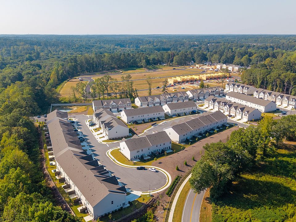 Community aerial showcasing homes, streets, and green spaces from above.