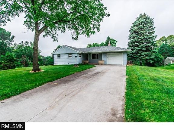 Front of the home show the 2nd concrete driveway and 3rd garage stall. Note large mature trees.  A great neighborhood.