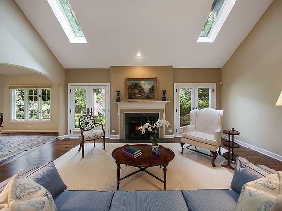 Vaulted ceiling, skylights with electric shades, French doors to brick patio, fireplace, hardwood fl